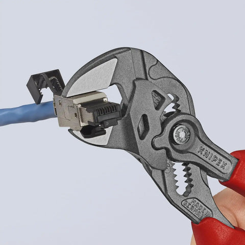 7.25 Inch Pliers Wrench With Smooth Jaws And Black Finish gripping a cable connector, showing red grip handle.