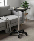 Flexible Mobile Standing Desk With Smooth Rolling Wheels And No Sweat Height Adjustments Solid Flat Top Laptop Table by a couch.