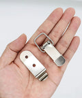 8 Pack Stainless Steel 90 Degree Spring Toggle Lock Latches with mounting screws for boxes and cabinets, on a palm view