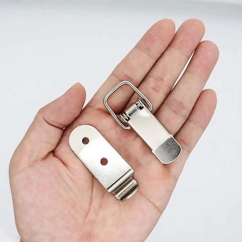 8 Pack Stainless Steel 90 Degree Spring Toggle Lock Latches with mounting screws for boxes and cabinets, on a palm view
