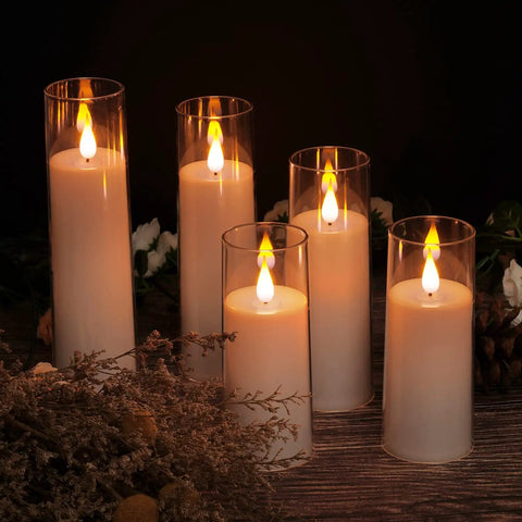 Image of a set of 5 battery operated flameless LED pillar candles with acrylic shell and realistic 3D wick, warm yellow glow, 5 to 8 inch heights.