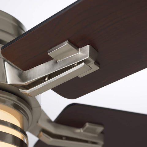 Close-up of 54-inch indoor ceiling fan with reversible wood blades in brushed steel fixture