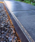 All In One Stainless Steel Trench Drainage System Kit With Outdoor Grate For Courtyards And Driveways installed beside driveway