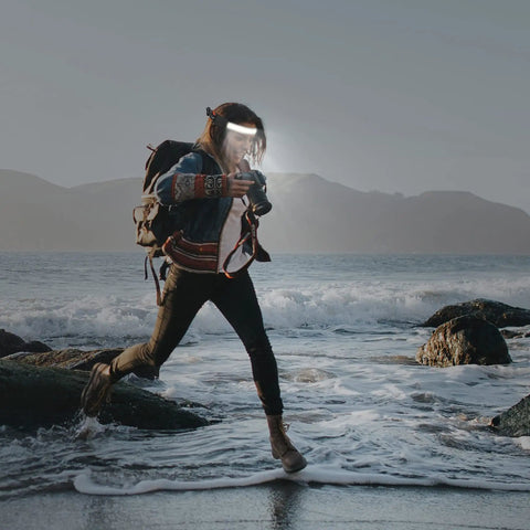 Person running on rocky beach wearing 2 Pack LED Headlamp Flashlight 1000 Lumen Rechargeable Beast Mode Bright With 230 Degree Wide Beam Red Taillight 8 Clips