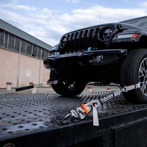 Complete Axle Strap Tie Down Kit With Snap Hook Ratchet Straps Silver Series Webbing in use securing a vehicle on a trailer