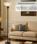 Bronze 72 Inch Torchiere Floor Lamp With Glass Shade in cozy living room corner.
