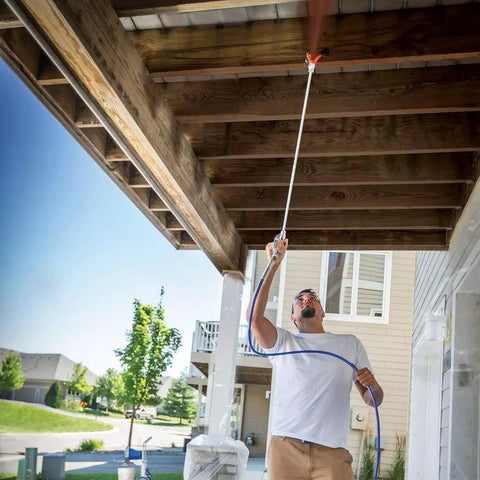 Person using 30 Inch Tip Extension With RAC V Guard For Sprayers, great for ceilings and eaves, helps you stay off ladders, easy assembly
