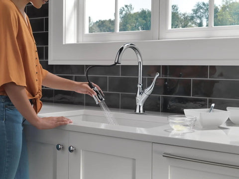 Ophelia Chrome Kitchen Faucet With Pull Down Sprayer in use at modern sink, high arc design with ShieldSpray technology reducing splatter