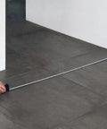 Using Self Locking Tape Measure Pocket Size Retractable Dual Unit Feet Meters Gadget on gray tiled floor