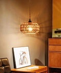 Two Pack Mini Rattan Plug In Pendant Lights Hand Woven Boho Ceiling Fixture With Switch Easy Install Home Upgrade For Bedroom Entryway Hallway Cozy Vibes hanging over a wooden side table with artwork.