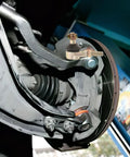 Close-up of Built Tough Golden Alloy Castle Nut Kit for Go Kart Steering Rod Replacement attached to vehicle mechanism