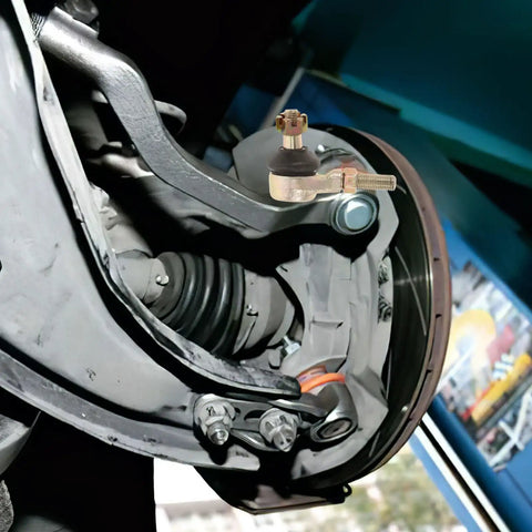 Close-up of Built Tough Golden Alloy Castle Nut Kit for Go Kart Steering Rod Replacement attached to vehicle mechanism
