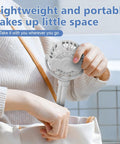 Person placing Mini Portable Baby Stroller Fan On The Go, 3 Speed Personal Handheld Cooling, into a bag.