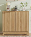Front view of a fluted double tilt-out trash can cabinet with odor control and built-in outlets, used as coffee station.