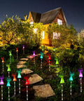 Solar Angel Lights Outdoor Decor Set Of 2 with Fiber Optic Wings illuminating a garden path at night with color changing LED beads.