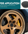Street Ready Wheel Center Caps 4 Pack Rust Proof Hub Covers No Sweat Snap In Anti Drop Rim Medallions Tough Steel Bracket Universal Slick Black Car Truck Bling Setup close-up on black car rim with gold spokes and black center cap