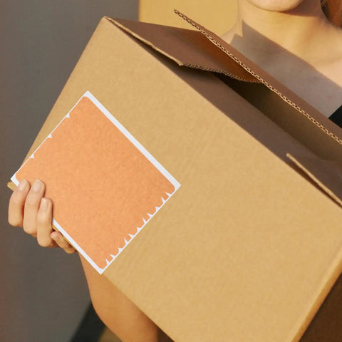 Heavy Duty Brown Paper Tape With Printable Surface And Easy Tear Strip For Sealing Cardboard Boxes held by person