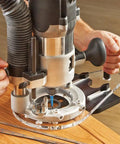 Universal Offset Router Base Plate For Precision Woodworking Clear Acrylic Foot in use with router for detailed wood cutting.