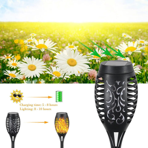 Close-up of Eight Pack Solar Flickering Flame Torches For Outdoors Waterproof Garden Lights against a daisy field backdrop.