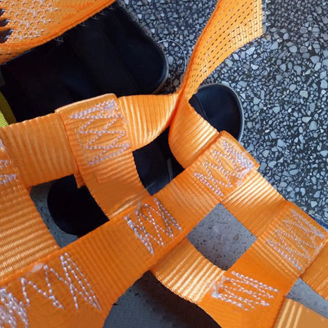 Close-up of Heavy Duty Polyester Sling Net for Easy Load Handling and Lifting with reinforced stitching in orange