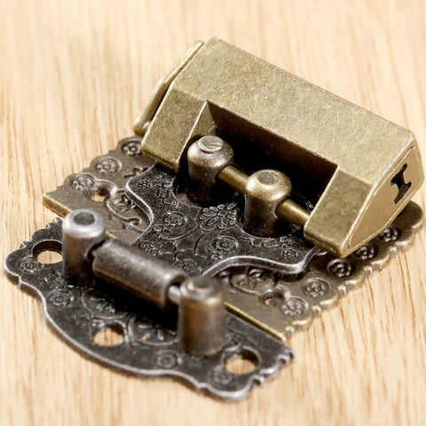 Two Pack Antique Bronze Cabinet Hinges With Lock Latch Hasps For Vintage Wooden Boxes And Cupboards close-up on wood surface