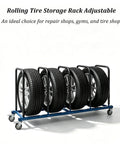 Built Like A Tank Heavy Duty Tire Stand With Smooth Rolling Locking Casters Rust Proof Steel Rack holding four tires securely in a workshop.