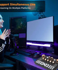 Pro Gaming Audio Mixer Sound Board for PC and Phone on desk setup with microphone and dual monitors