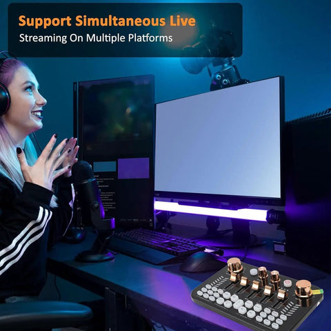 Pro Gaming Audio Mixer Sound Board for PC and Phone on desk setup with microphone and dual monitors