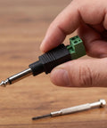 Straight Up 1/4 Inch Jack Mono Male Plugs For Electric Guitar And Stage Mixer Cables 6.35mm in hand with green connector.