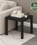 Classic Homey Square Parsons Side End Table In Black 1 Pack next to a sofa, featuring a minimalist design with 1.8 inch thick top