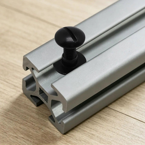 Hella Strong 1/4 20 Centered Slide T Nuts For T Slot Track Paired With Matching 1/4 20 X 1/2 Bolts In Classic Black Coat on aluminum extrusion.