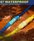 Close-up of blue and yellow heat-shrink insulated butt connectors crimped to wires on a rusty surface.