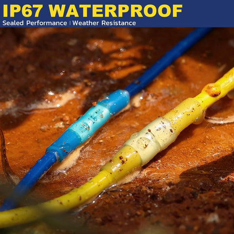 Close-up of blue and yellow heat-shrink insulated butt connectors crimped to wires on a rusty surface.