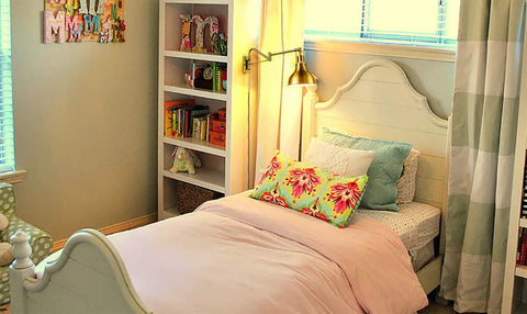 Bedroom with bed, colorful pillows, bookshelf, and Plug In Gold Swing Arm Wall Sconces Set Of Two Modern Brass Finish Wall Lamps With White Dome Shade.