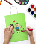 Child decorating a green gift bag from the 32 Piece Gift Bags Set With 32 Tissues Eight Color Rainbow Party Favors With Handles For Wedding Birthday Parties And Gifts Ideal For Gift Wrapping Party Decor Event Giveaways School And Baby Showers.