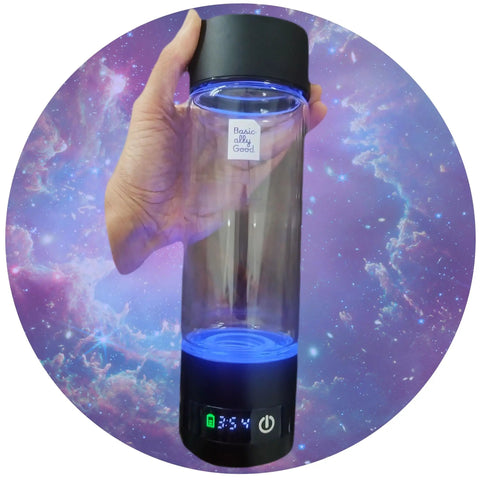 Hand holding Portable Hydrogen Water Bottle Generator For Everyday Hydration Hack With Purifying Tech, Glass BPA Free Bottle against galaxy background
