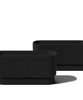 Black long planter for porch patio and backyard in durable plastic stone composite fluted all weather outdoor pot for shrubs and flowers.