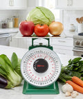 50 Lb Heavy Duty Mechanical Dial Kitchen Scale with Stainless Steel Platform showing fruits and vegetables on scale in kitchen setting