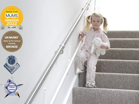 Fully Adjustable Toddler Stair Handrail Built Like A Tank For Little Ones Grows With Your Kid To Deliver Kid Approved Safety And Rock Solid Support Down Each Step Zero Hassle Standard Mount Kit with toddler in pajamas using handrail on stairs.