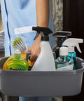 Person carrying a large cleaning supplies caddy organizer bin with handle for dorm garden bathroom under sink storage tote