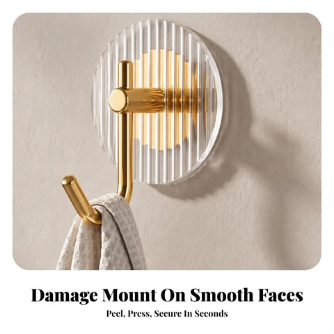 Kick Clutter To The Curb With This Slick Space Saving Wall Hook on smooth surface holding a towel, featuring striped acrylic and gold metal.
