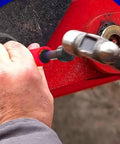 Man using Grease Fitting Cleaner Tool Kit Hydraulic Powered Zerk Buster And Rejuvenator on red machinery joint