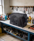 Kick Some Dust This Heavy Duty Bench Grinder Cover features tough 420D Oxford fabric, protecting a six or eight inch grinder on a workbench.