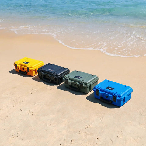 Four waterproof hard cases for DJI Mini 4 Pro Mini 3 Pro and RC transmitters in yellow, black, green, and blue on a beach.
