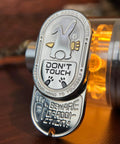 Solid Metal Fidget Slider For Adults with engraved rabbit design and warning text, premium desk accessory for stress relief.