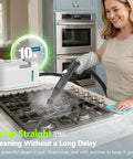 High Performance 2500W Handheld Steam Cleaner With Auto Stop And 15 Piece Accessory Kit being used on a stove, producing steam in 10 seconds.