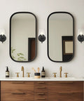 Gold Wall Sconce Lighting Set Of 2 With Frosted Champagne Glass Shade for bathroom on either side of mirrors in modern setting.