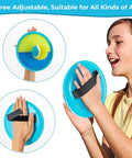 Child playing with Outdoor Toss And Catch Ball Set For Kids Beach Toys And Backyard Games Perfect For Backyard Playgrounds And Beach Trips With 6 Balls And 3 Paddles Includes Storage Great Easter Gift Light Blue, holding paddle with adjustable strap.