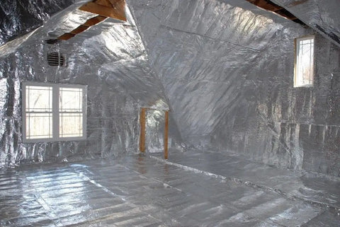 Premium Radiant Barrier Insulation Foil Roll Covers 1000 Square Feet Four Feet Wide installed in an attic space.