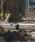 Construction site with pipe secured by 304 stainless steel band 1 inch wide 0.044 inch thick with clamps for tough tie downs